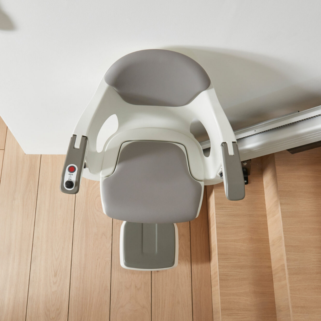 Arial close-up of AccessBDD HomeGlide straight stairlift chair with gray seat