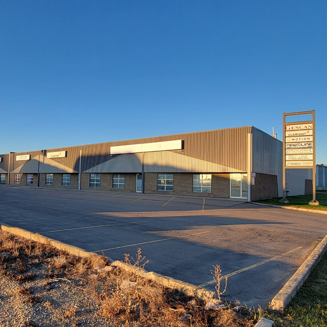 Grande Prairie exterior wide view of plaza including Motion facility on far left and Motion logo on pylon sign third from top.