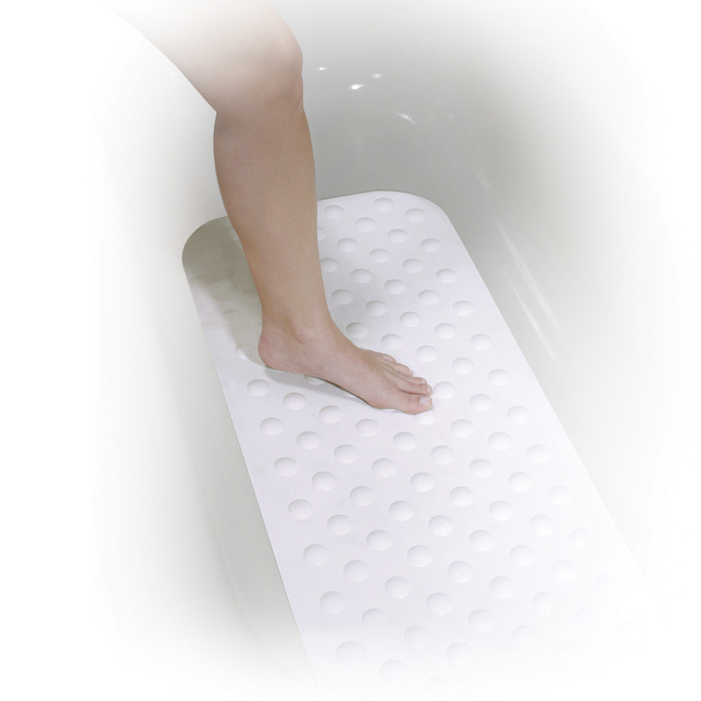Womans foot and leg entering a white bath tub and stepping on a white bath mat