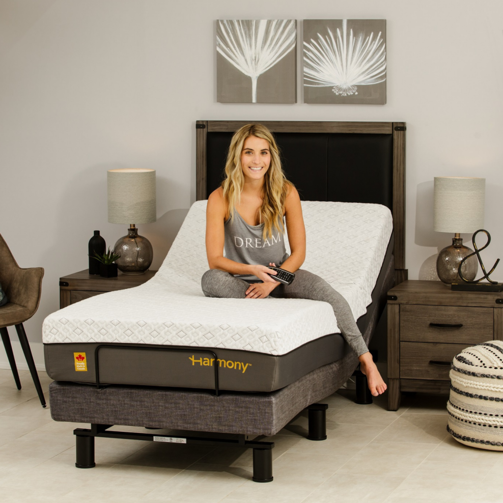 Young woman sitting on the harmony adjustable bed base.
