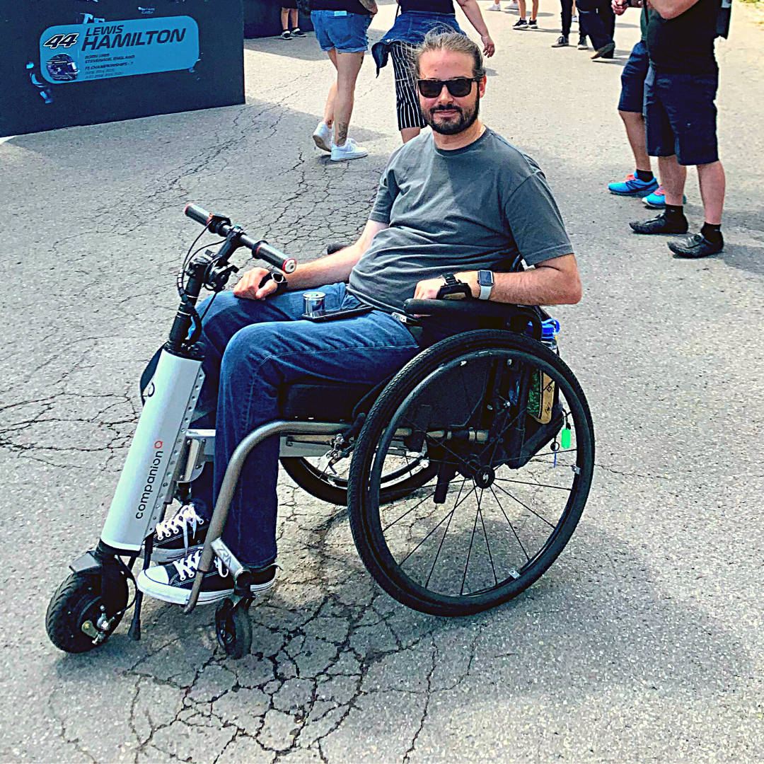 Motion Client Ambassador Beau Hayward at Montreal Grand Prix using Cheelcare Companion device with manual wheelchair