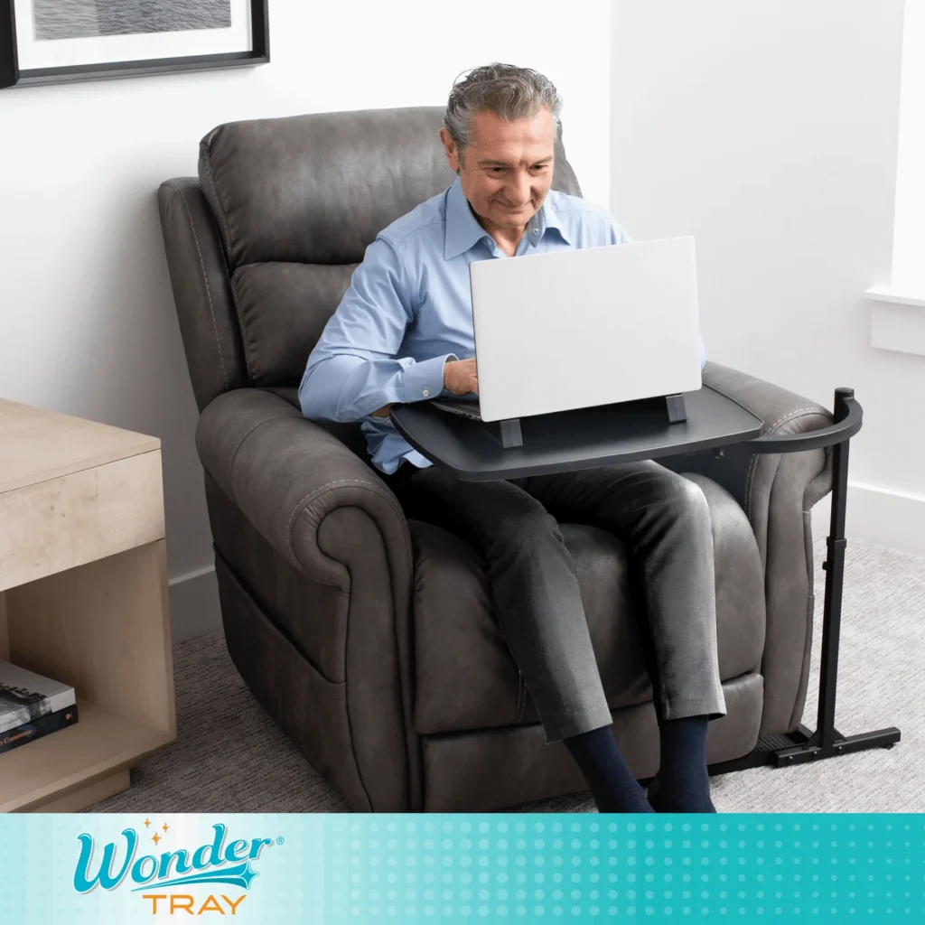 Senior man on his laptop using the Wonder Tray.