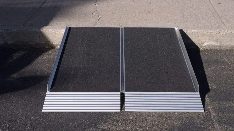 A black and aluminum folding National Ramp ramp outside. 