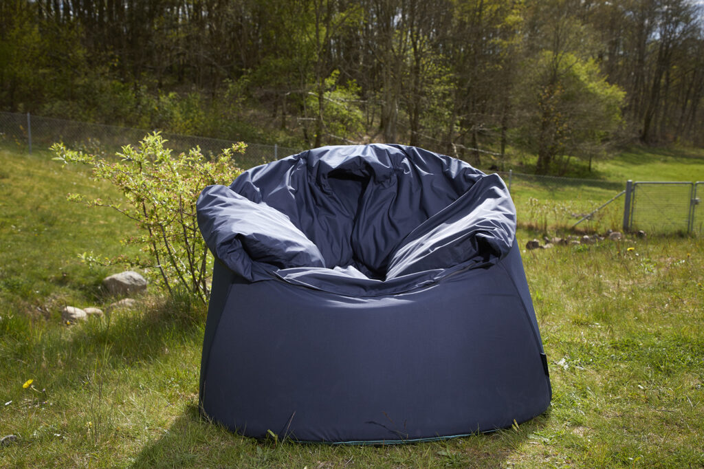 SenSit Nature in navy, outside on grass. 
