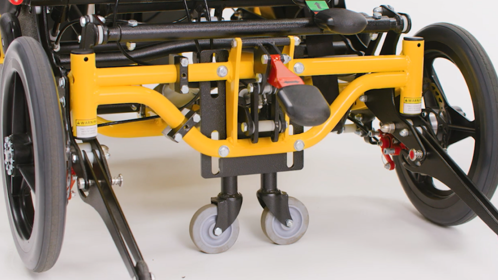 A close-up of the wheels of a Traversa Wheelchair by Broda. 