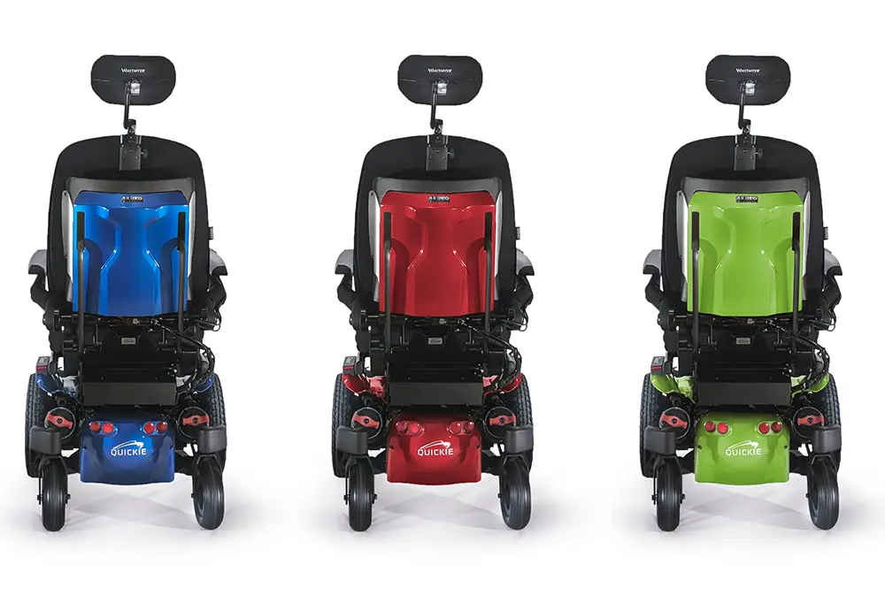 3 Quickie 700M power wheelchairs in blue, red and green. 