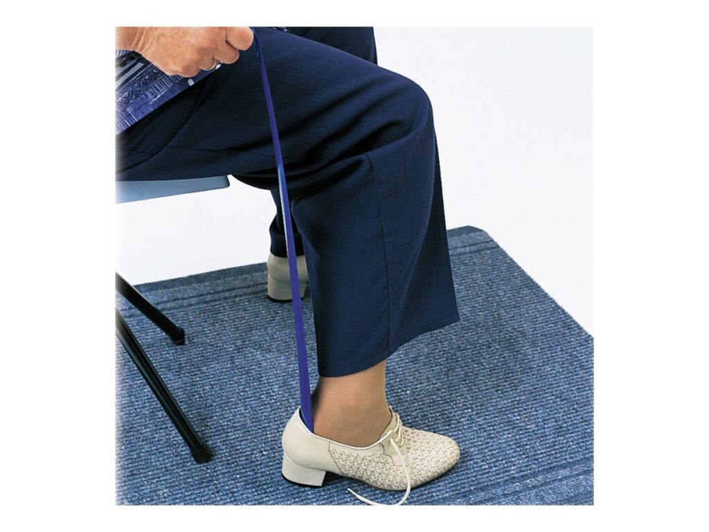 A blue metal show horn from Drive Medical being used on a white shoe.